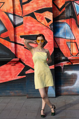 Asian Chinese model girl influencer street shot. Wearing yellow patterned sundress.  Street view background.
