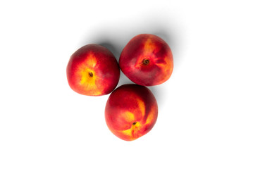 Three peaches isolated on white background. Top view.