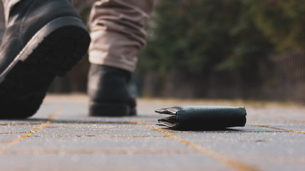 Someone lost his wallet. Man walking away from lost object