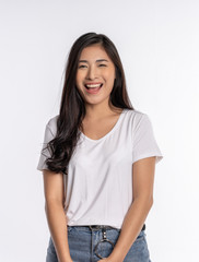 happy young Asian woman smiling and standing over white wall background. Looking camera , she is very excited