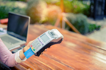 Asian woman paying by credit card at gift shop ,woman hands entering security pin in credit card reader swipe through terminal for payment in booth,buy and sell products service,internet of things
