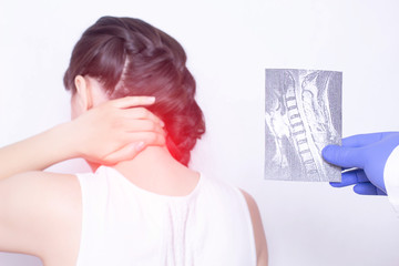 The doctor conducts a medical examination. She holds an X-ray examination of a girl who has pain in...