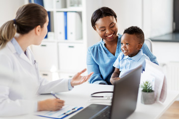 medicine, healthcare and pediatry concept - happy african american mother with baby son and caucasian doctor at clinic - Powered by Adobe