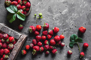 Delicious strawberries on a dark gray background in a vintage wreath. Healthy food, fruit