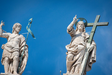 Vatican City - APRIL 17, 2019: Statue of Jesus on the top of Saint Peter Basilica facade ..