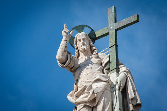 Vatican City - APRIL 17, 2019: Statue of Jesus on the top of Saint Peter Basilica facade ..