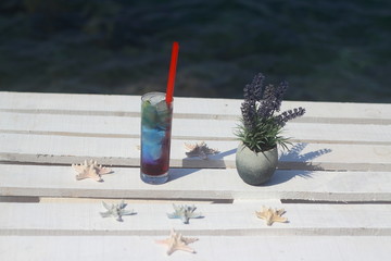 Summer cocktail on the background of the sea. Summer vacation, relaxation, summer party.