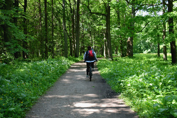 young woman riding bicycle in the park