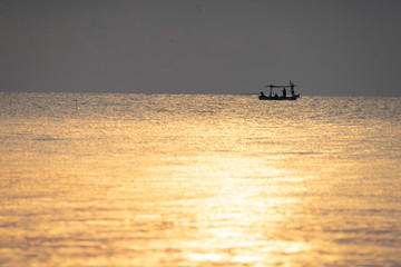 Local fishing boat on the sea with sunrise scene in Sam Roi Yot National Park, Thailand.