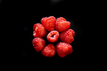 raspberries on black background