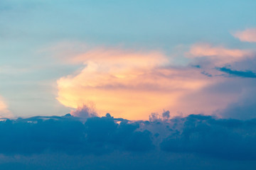 sunset twilight with picturesque orange fiery coral clouds in the rays of the setting sun