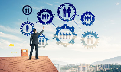 Businessman on house roof presenting teamwork and connection con