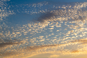 sunset twilight with picturesque orange fiery coral clouds in the rays of the setting sun