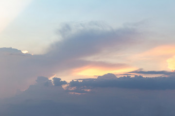 sunset twilight with picturesque orange fiery coral clouds in the rays of the setting sun