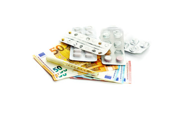 Pills and euros on a white background close-up.