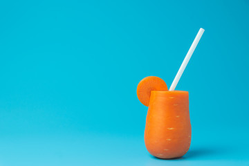 Carrot on blue background for healthy concept.