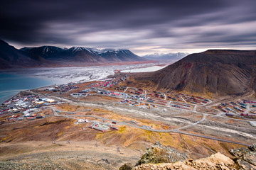 Svalbard mountain landscape, view from above Longyearbyen at Adventdalen Fjord in late autumn with dark clouds