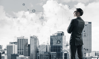 Concept of business success and control with confident boss against cityscape background