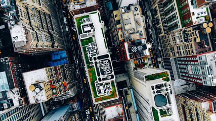 Aerial view of New York downtown building roofs with water towers. Bird's eye view from helicopter...
