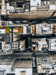 Aerial view of New York downtown building roofs with water towers. Bird's eye view from helicopter of cityscape metropolis infrastructure, traffic cars moving on city streets and district avenues