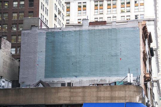 Side of a building in New York with painted-over advert space