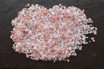 Pink himalayan salt on slate background. 