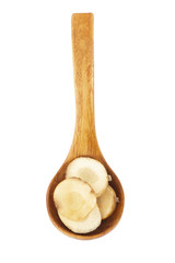 heap of slices of fresh galangal root  in wooden spoon isolated on white background. top view