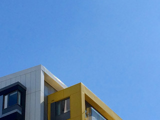 Low angle view of Manchester modern buildings against clear blue sky