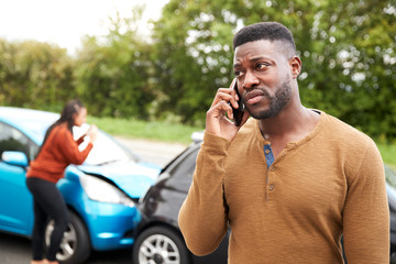 Male Motorist Involved In Car Accident Calling Insurance Company Or Recovery Service