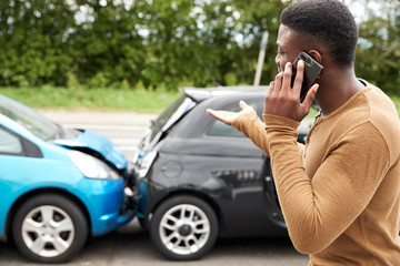 Male Motorist Involved In Car Accident Calling Insurance Company Or Recovery Service