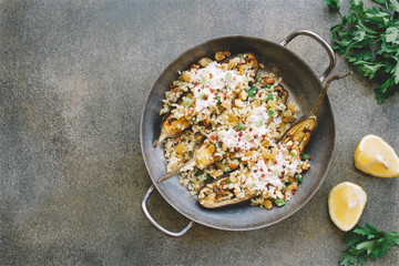  Eggplants, Aubergines Stuffed with bulgur, raisins, almonds and yogurt served on pan.  Top view, copy space