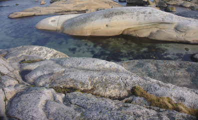 transparent water going through rocks