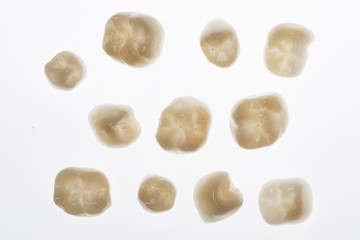 beautiful ceramic dental crowns for white background with backlight, before pasting total work