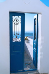 Blue door opened to a terrace with sea views.