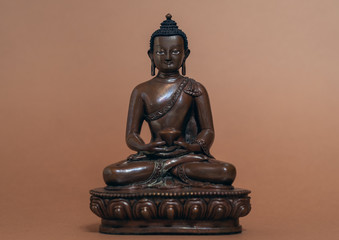 Amitabha buddha statue on brown background