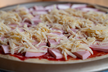 cooking delicious pizza with slices of sausage and cheese close-up
