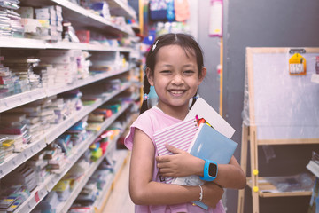 Asian Student in stationery store buying notebook with smile and happy.Back to school concept