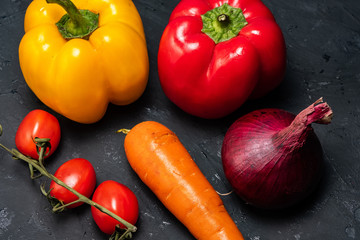 a healthy lifestyle is the layout of the vegetables, tomato, pepper.onions and carrots