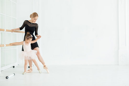  Little Ballerina Dancing with Ballet Teacher in Dance Studio - Image 