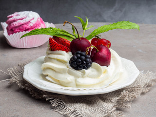 Homemade pink marshmallow and pavlova cake with strawberry, blackberry, currant, cherry and mint leaf