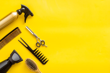 Hairdresser equipment for cutting hair and styling with combs, sciccors, brushes on yellow...