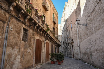 Fototapeta na wymiar Typical picturesque narrow street in the Old Town of Bari, Puglia region, Southern Italy.