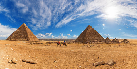Fototapeta na wymiar Bedouins near the Pyramids of Giza, sunny day panorama