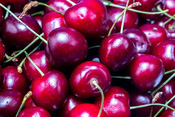 ripe red cherries on a white plate