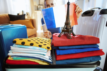 Closeup on woman showing French flag and Eiffel tower souvenir