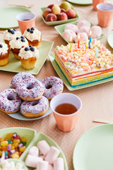 Above view background image of dinner table set with sweets and cake for Birthday party , copy space