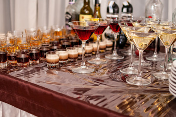 Desserts in the glasses lying on the brown table