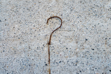 Concrete surface with rusty bent rebar.