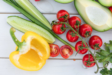 Fresh organic vegetables, cherry tomatoes, avocado, cucumbers, carrot, red and yellow pepper, green. Vegan food, healthy lifestyle concept