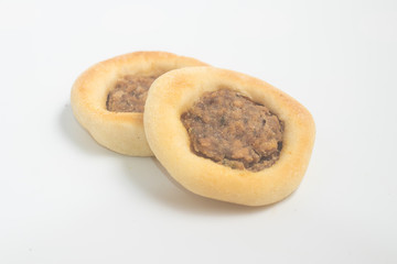 Arabic Meat sfiha over a wooden table.